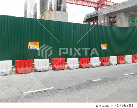 KUALA LUMPUR, MALAYSIA -JUNE 27, 2020: Plastic jersey barrier is a modular barrier that is temporarily used to reroute traffic and protect pedestrians while construction is underway.  71766881