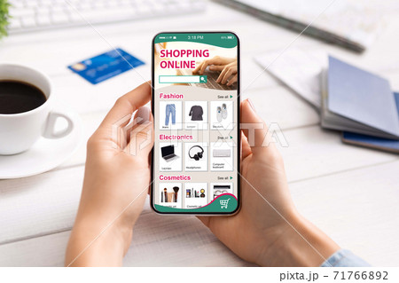 Woman Using Phone For Online Shopping Sitting At Desk Indoor 71766892