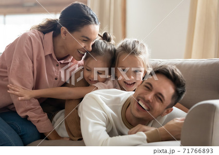 Happy carefree loving family with daughters relaxing at home 71766893