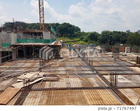 KUALA LUMPUR, MALAYSIA -NOVEMBER 21, 2020: Building floor slab under construction. Construction workers fabricating the timber formwork and installing the steel reinforcement bar.  71767497