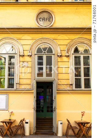 A street bad square at the entrance to a vintage cafe in the city of old Europe A street bad square at the entrance to a vintage cafe in the city of old Europe 71768001