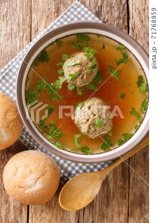 Leberknodelsuppe German liver dumpling soup close-up in a plate. Vertical top view Leberknodelsuppe German liver dumpling soup close-up in a plate. Vertical top view 71768959