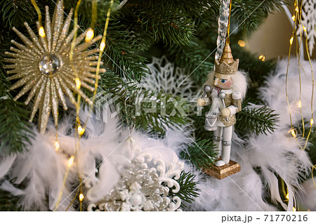 Close up of Christmas tree with ornaments of baubles, pine cones and lights. Close up of Christmas tree with ornaments of baubles, pine cones and lights. 71770216