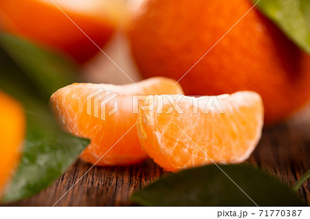 Two slices of juicy tangerine. Two slices of juicy tangerine. 71770387