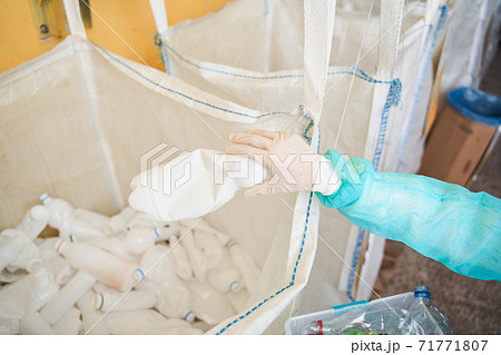 Woman sorting plastic bottles by colors 71771807