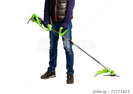 Man hold green grass electric trimmer indoors 71771825