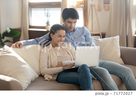 Bonding couple in love having date at home using laptop 71772027
