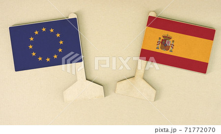 Flags of the European Union and Spain made of recycled paper on the cardboard desk, flat layout Flags of the European Union and Spain made of recycled paper on the cardboard desk, flat layout 71772070