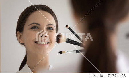 Smiling young lady makeup artist holding professional brush set Smiling young lady makeup artist holding professional brush set 71774168