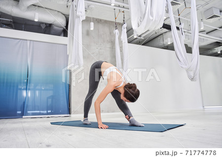 Woman in sportswear doing stretching 71774778