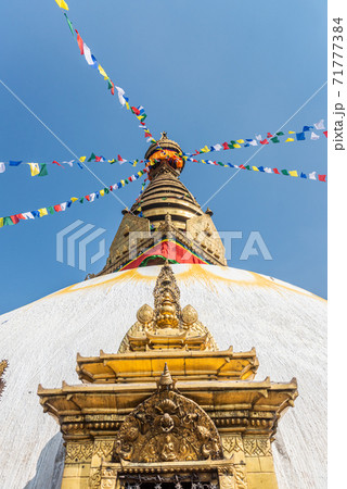 Tower of the Boudhanath Stupa decorated with flags in Kathmandu, Nepal. 71777384