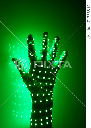 human hand covered with green led lights, illuminated background human hand covered with green led lights, illuminated background 71778316