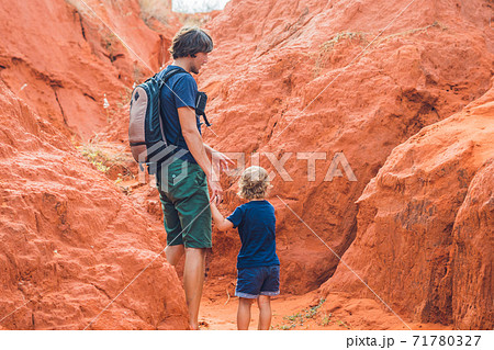 Father and son travelers in red canyon near Mui Ne, southern Vietnam. Traveling with children concept 71780327
