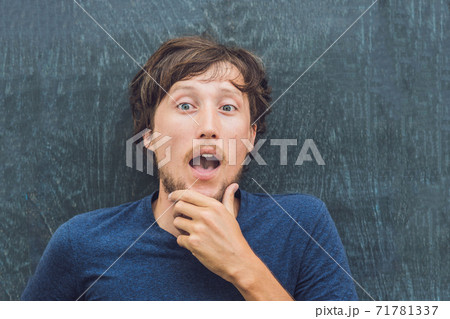Top view of a young man with space for text and symbols on the old wooden background. Concept for confusion, brainstorming and choice 71781337