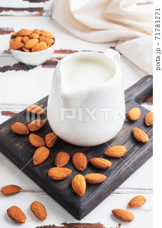 Almond milk in ceramic milk jug on a gray background. Copy space. Almond milk in ceramic milk jug on a gray background. Copy space. 71783271