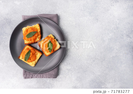 Sandwich with toast and zucchini caviar. Vegetable caviar on bread, a healthy vegetarian snack. Black plate copy space. Sandwich with toast and zucchini caviar. Vegetable caviar on bread, a healthy vegetarian snack. Black plate copy space. 71783277