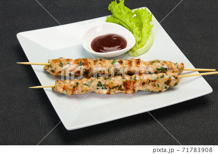 Minced pork skewer kebab with sauce 71783908