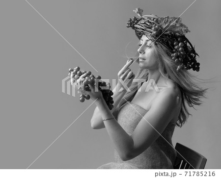 Portrait of  beautiful caucasian blonde woman with grapes. 71785216