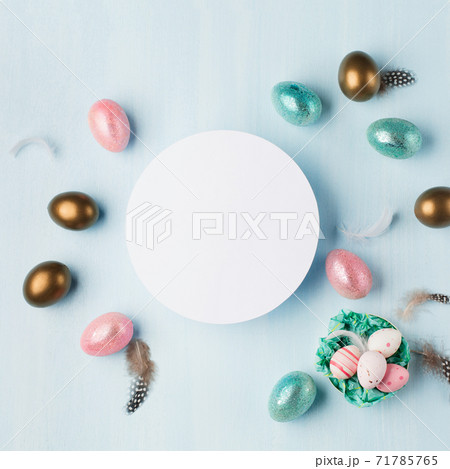 Easter greeting card with colorful easter eggs on blue background. Top view, flat lay with space for your text. Easter greeting card with colorful easter eggs on blue background. Top view, flat lay with space for your text. 71785765