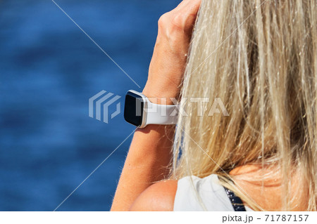 Smartwatch on the girl hand on the background of the sea Smartwatch on the girl hand on the background of the sea 71787157