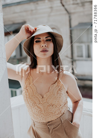 Beautiful oriental fashionable brunette woman in beige clothes 71788366