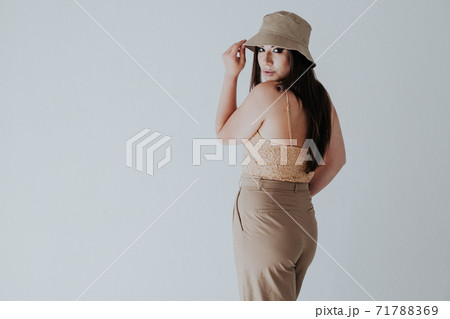 Beautiful oriental fashionable brunette woman in beige clothes 71788369
