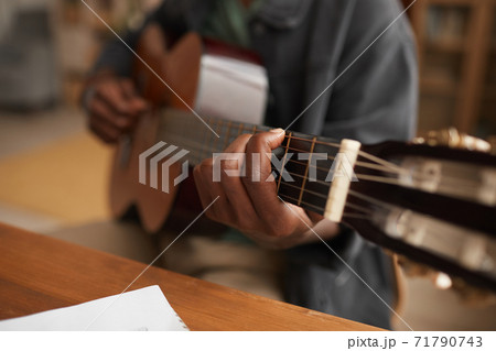 African-American Man Playing Guitar Close Up 71790743
