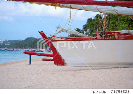 White beach of Boracay island. A sailing boat named Boracay is on the beach. Tourists walk along the beach and swim in the sea. A few days before the outbreak of the coronavirus. 71793823