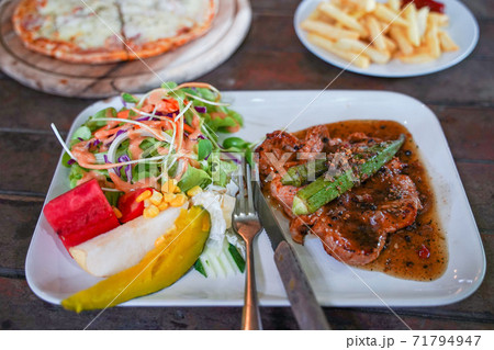 Pork chop steak with black pepper sauce 71794947
