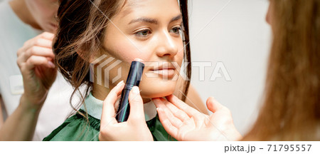 Makeup artist applying cream blush stick Makeup artist applying cream blush stick 71795557