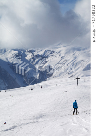 Skier descend on snowy ski slope Skier descend on snowy ski slope 71798322