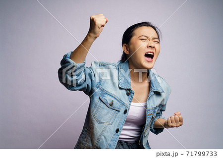 Asian woman shouting isolated over white background. 71799733
