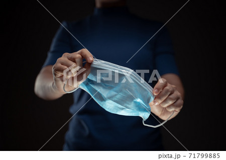 Close up shot of hands holding protective face mask. Close up shot of hands holding protective face mask. 71799885