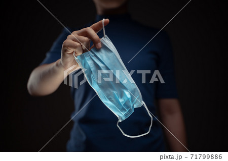 Close up shot of hands holding protective face mask. Close up shot of hands holding protective face mask. 71799886