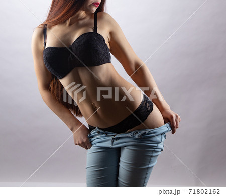 Sexy girl undresses in a black panties in a - Stock Photo [67785937] -  PIXTA