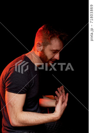 A man on a black background . Actively gestures . Explanation or conversation 71803869