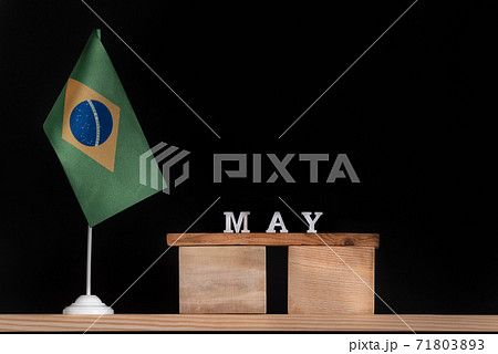 Wooden calendar of May with Brazilian flag on black background. Dates of Brazil in May 71803893