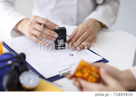 Doctor writes prescription for pills to patient Doctor writes prescription for pills to patient 71805816