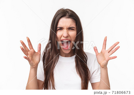 Close-up portrait of angry, pissed-off aggressive woman screaming at person, shouting and shaking hands from anger and disappointment, grimacing bothered, standing furious white background Close-up portrait of angry, pissed-off aggressive woman screaming at person, shouting and shaking hands from anger and disappointment, grimacing bothered, standing furious white background 71806673
