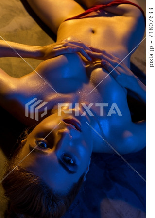 Alluring topless slim woman covering breast with hands 71807633