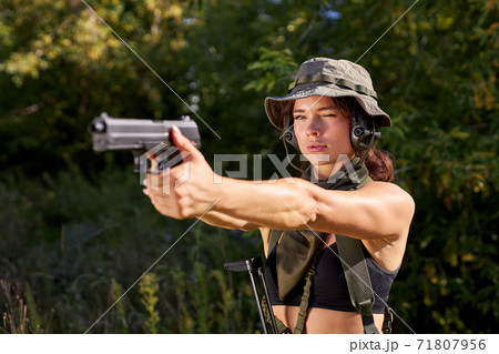 brave soldier woman practice shooting from gun 71807956