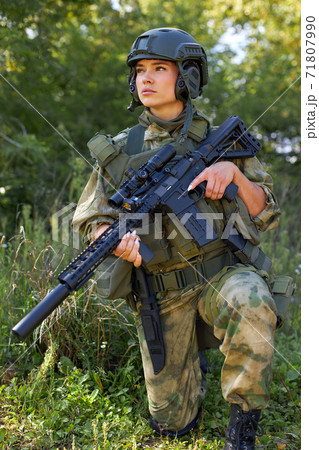 attractive brave military woman with a gun in forest, survival in wild forest attractive brave military woman with a gun in forest, survival in wild forest 71807990