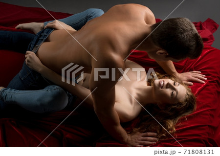 Passionate couple having sex on red sheets Passionate couple having sex on red sheets 71808131
