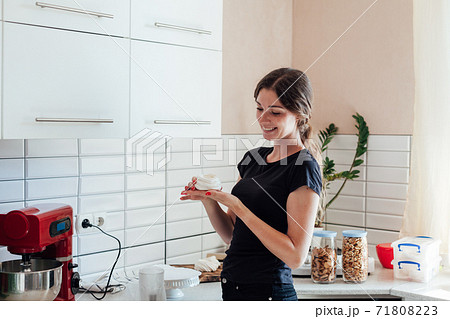 Woman prepares food in the kitchen with a kitchen harvester Woman prepares food in the kitchen with a kitchen harvester 71808223