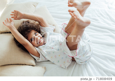 little girl woke up in the morning in the bedroom and laughs little girl woke up in the morning in the bedroom and laughs 71808409