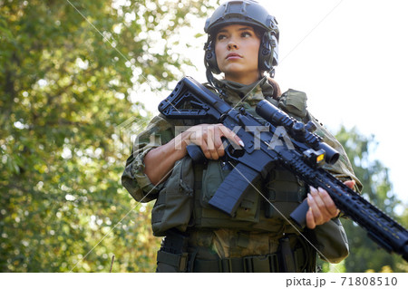 attractive brave military woman with a gun in forest, survival in wild forest attractive brave military woman with a gun in forest, survival in wild forest 71808510