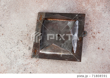 Antique brass chimney flap on gray oncrete background 71808591