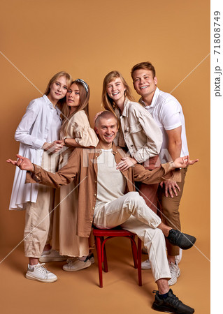 portrait of trendy stylish youth posing at camera isolated on brown 71808749