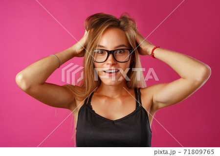 Shocked and amazed young blonde woman close up portrait. 71809765