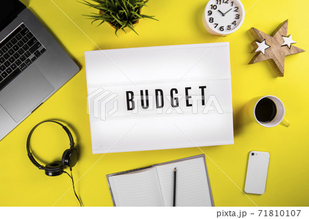 Budget word text on lightbox on modern yellow office desktop 71810107